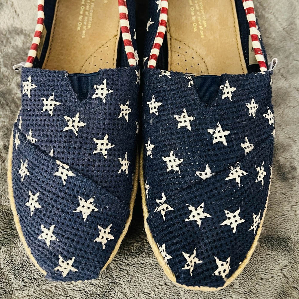 Toms red, white and blue alpargatas.